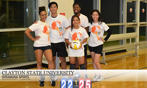 five members of women's volleyball team posing in victory