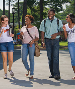 Students walking and talking on campus