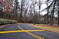 road showing paving with yellow lines