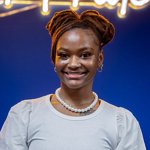 Image of Karmyn Jordon, wearing a white blouse and pearls