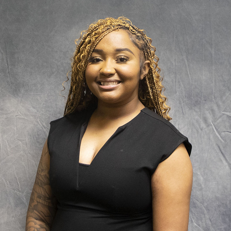 Image of Ajanae Dorsey wearing a black sleeveless dress. 