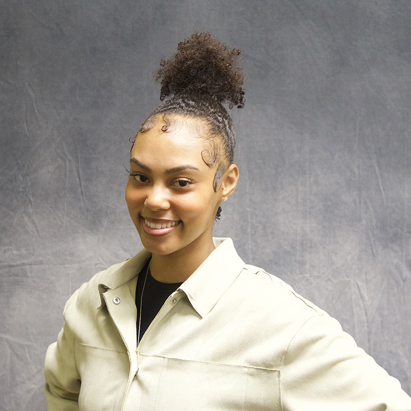 Image of Harlie Brown wearing a pale green button up shirt.