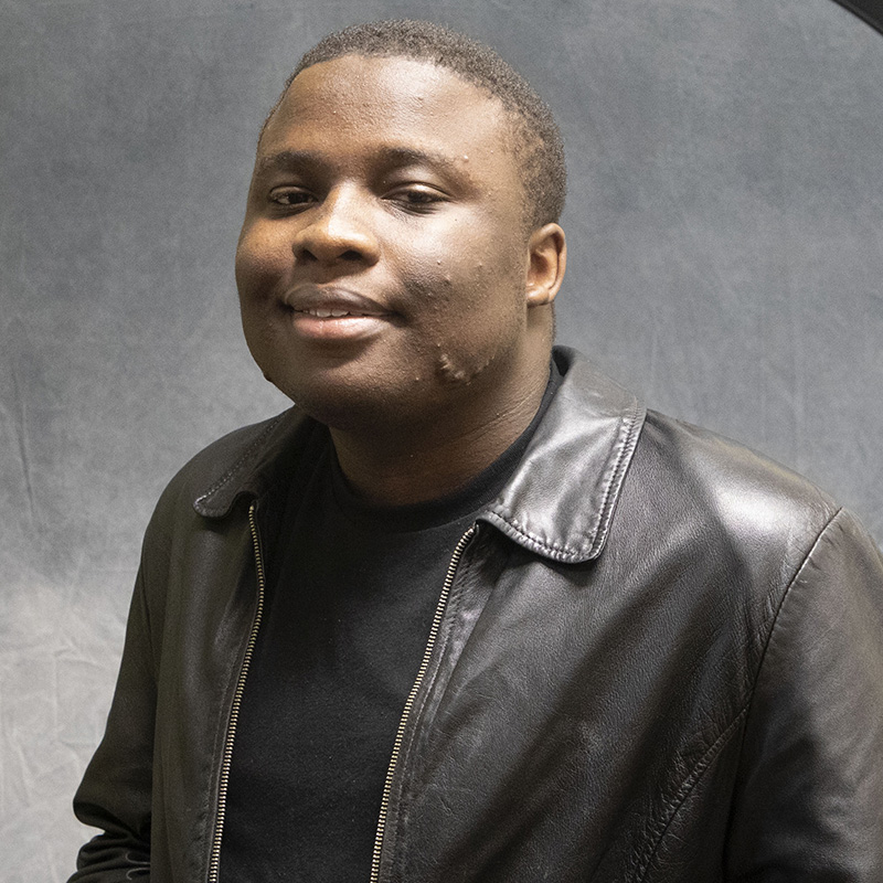 Image of Jalen Little wearing a black leather jacket and black t-shirt