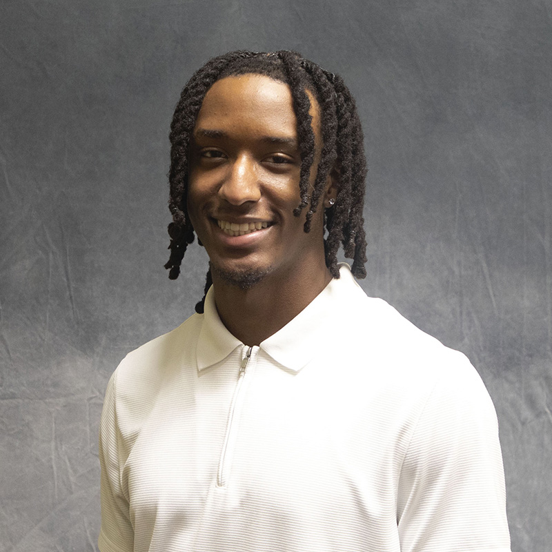 Image of Markeith Horace II wearing a white polo-style shirt. 