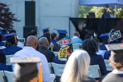 graduates and family listen to graduate ceremony