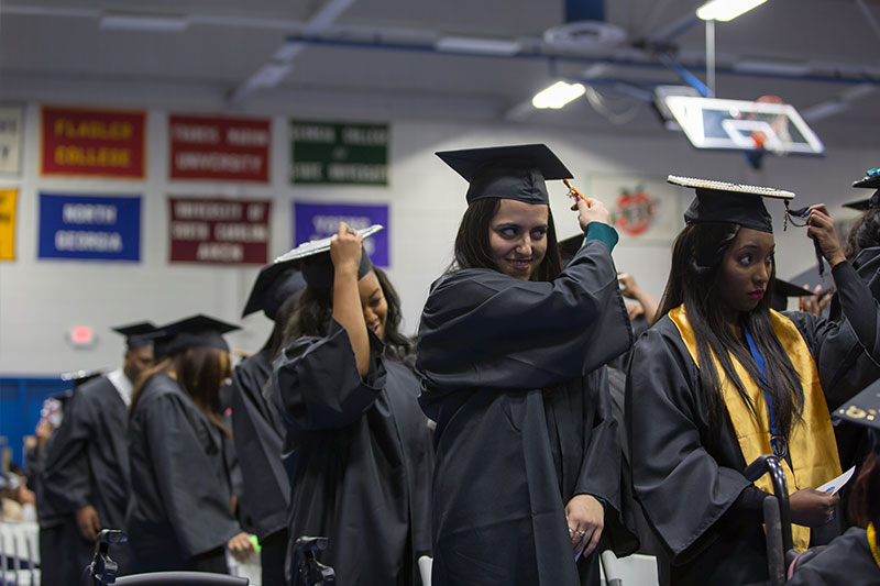 Graduates moving tassels over