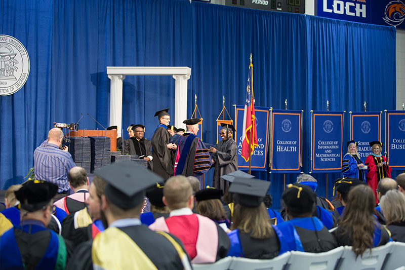 Student shaking President's hand