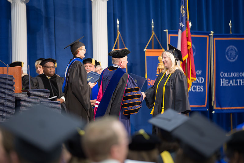 Student walking across stage