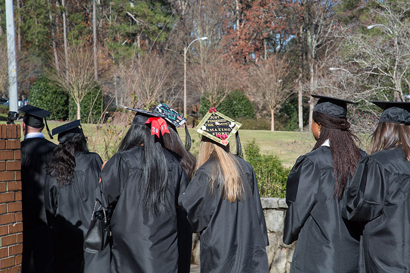 Graduates showing mortar board designs