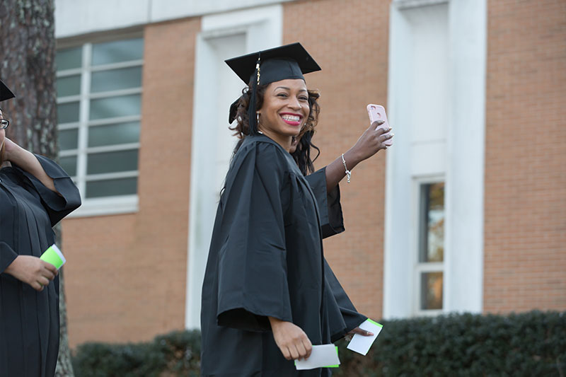 Graduate taking selfies