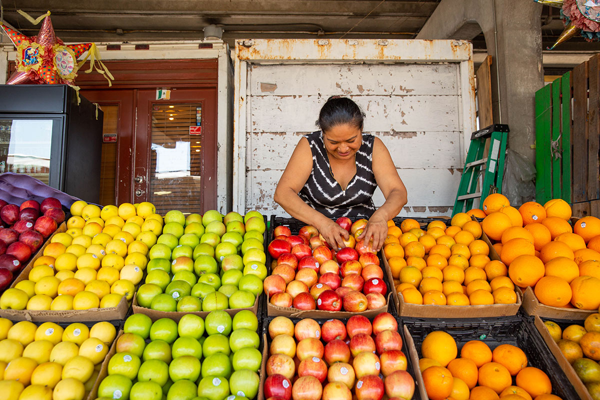 Lady organizing fruit at Farmer's Market