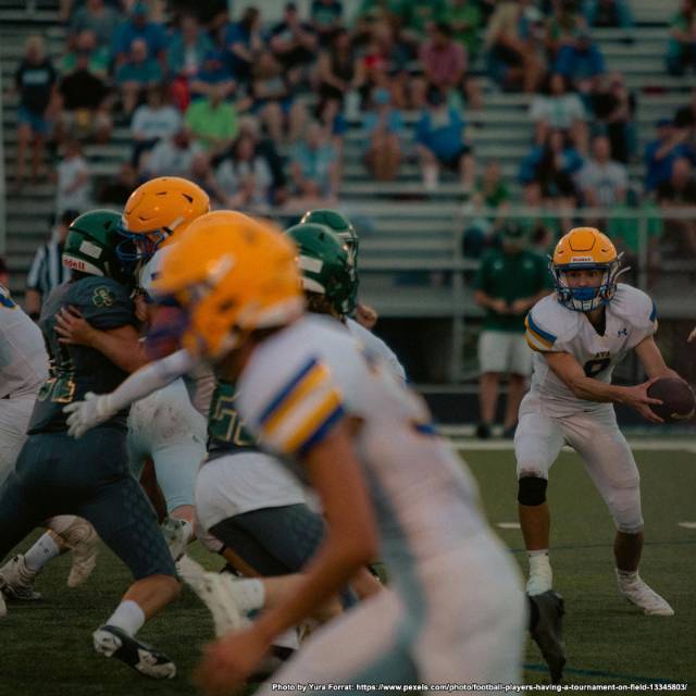 Club Sports Football players playing football, one team in green and the other in white and orange