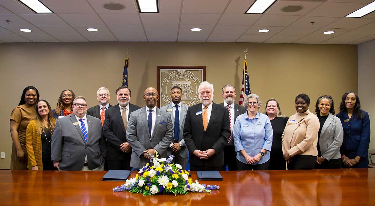 Members of Clayton State and Chattahoochee Technical College stand together following new articulation agreement signing