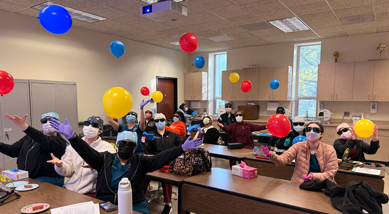 dental-hygiene-students-with-lasers-and-balloons-in-classroom