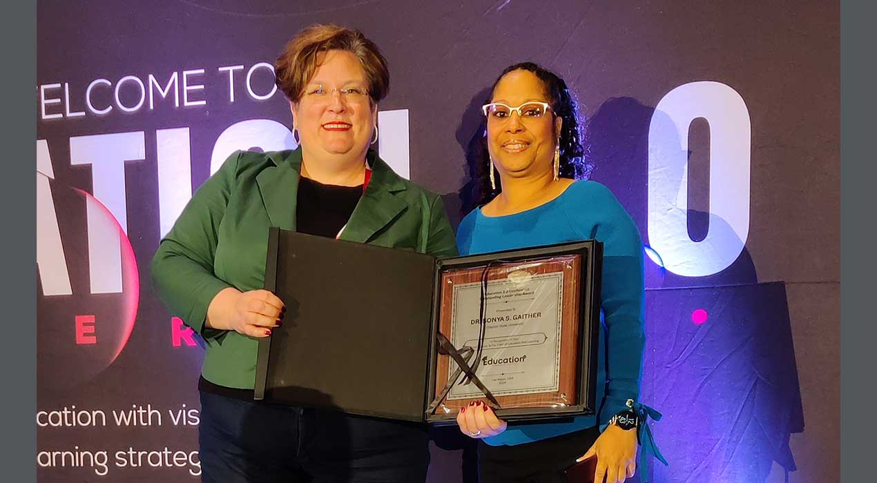 Dr. Gaither receives her award at the 2024 Education Education 2.0 Conference in Las Vegas