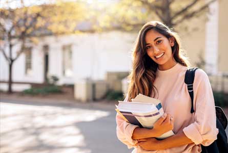 student holding books